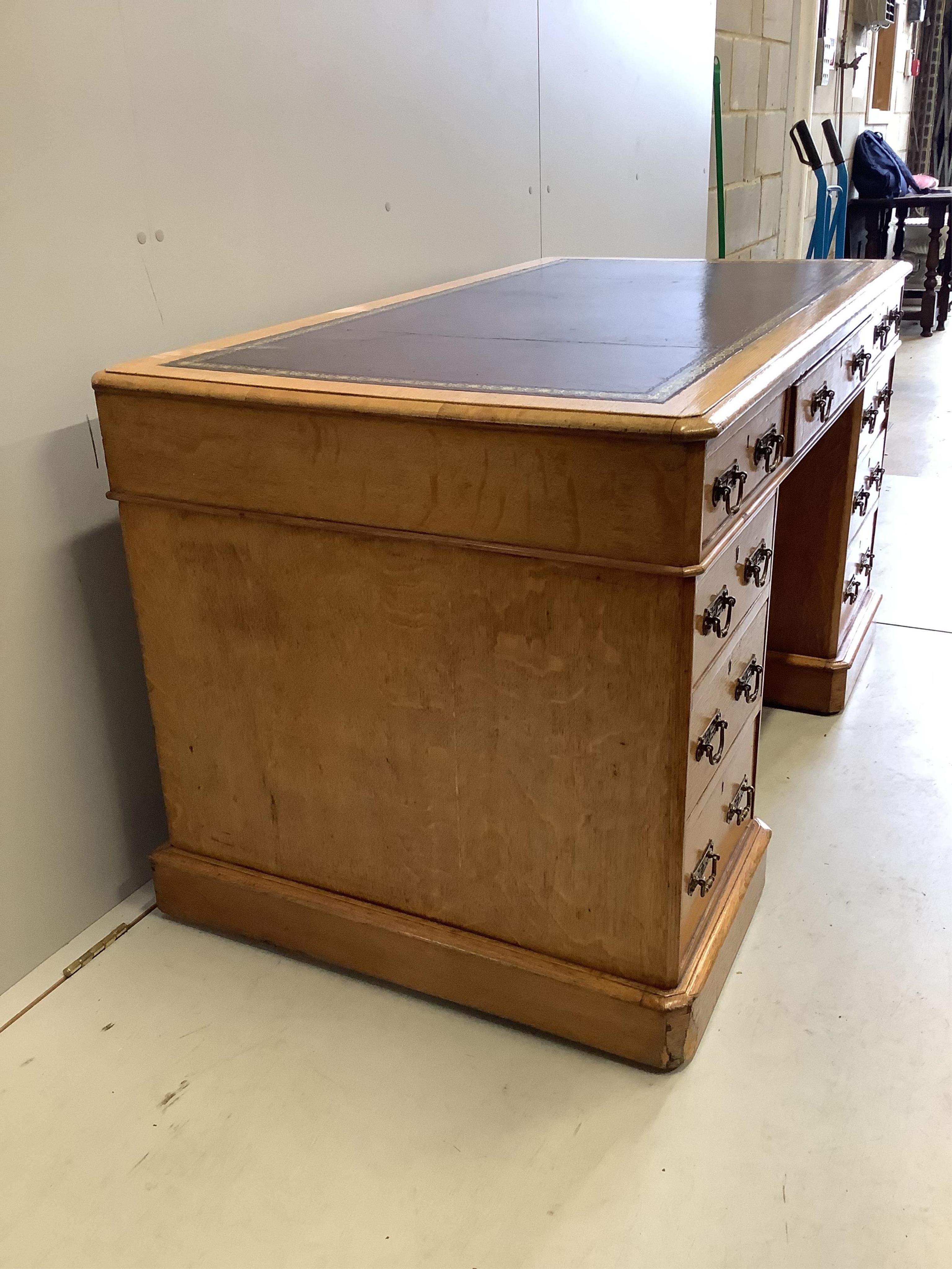 A Victorian golden oak pedestal desk, stamped E Buckham, width 136cm, depth 74cm, height 76cm. Condition - fair to good